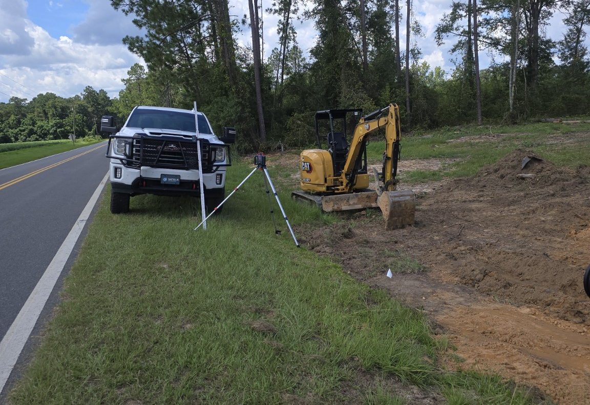 Satilla Site Solutions truck, layout equipment, excavation equipment, and active civil site work in Southeast Georgia